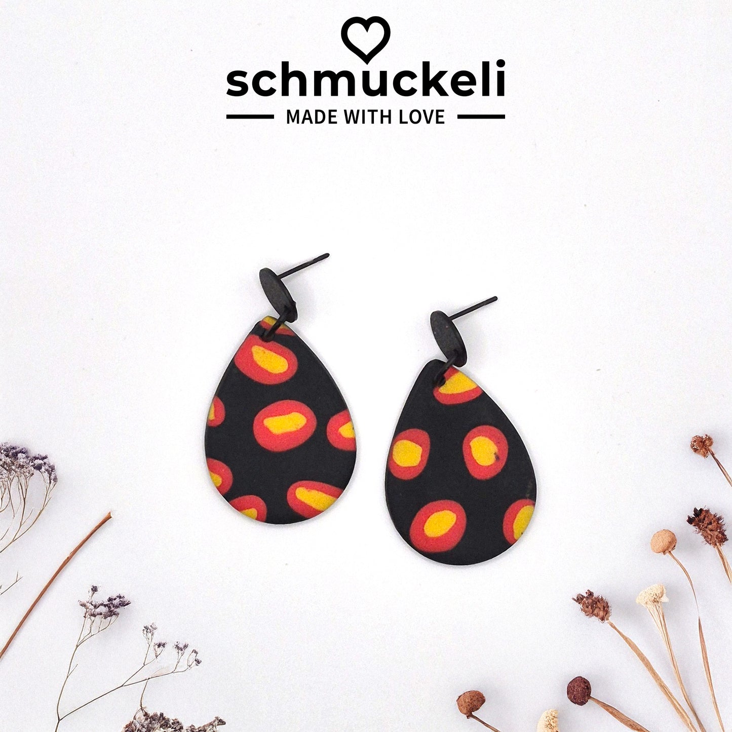 Feuerpunkt – Tropfenförmige Statement-Ohrringe in Schwarz mit leuchtendem Flammenmuster